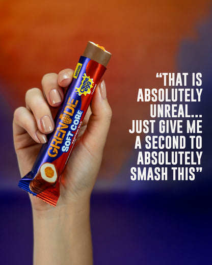 Hand holding a Grenade candy bar with a colorful background and text.